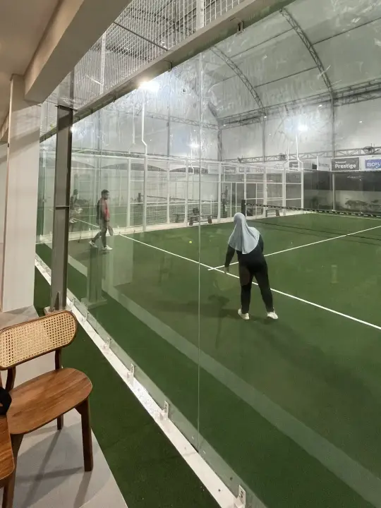 Court seen through the glass from a lounge chair